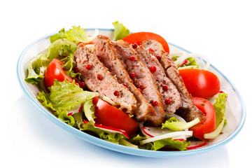 Grilled meat and vegetables on white background