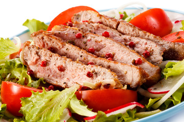 Grilled meat and vegetables on white background