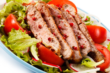 Grilled meat and vegetables on white background