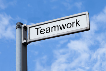 Signpost With Teamwork Sign Against Sky