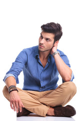 seated casual man looks away to his side