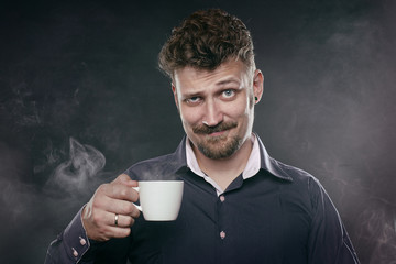 Handsome beard man stand in fog with cup of coffee in his hand - obrazy, fototapety, plakaty