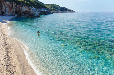 Family swimming in Aegean Sea (Mylopotamos beach, Greece).
