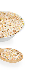 Porridge in white plate and wooden spoon