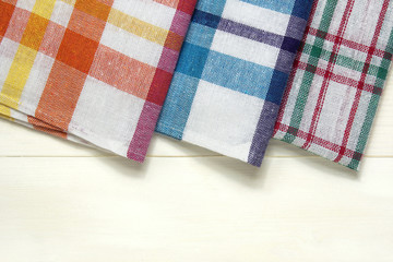 colorful dish towels on white wooden table