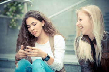 blonde and brunette beautiful stylish young women