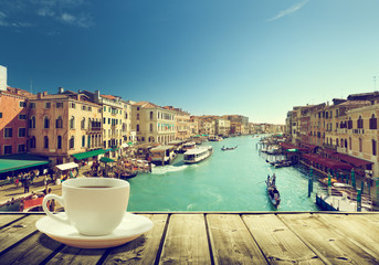 Fototapeta na wymiar coffee on table and Venice in sunset time, Italy