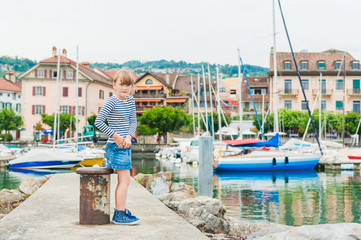 Fototapeta na wymiar Cute little girl resting in a port