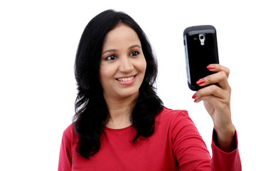 Fototapeta premium Young woman taking self picture