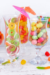 Different colorful fruit candy in glasses