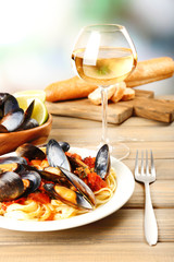 Tasty noodles with mussels on table, close up