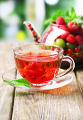 Fruit red tea with wild berries in glass cup,