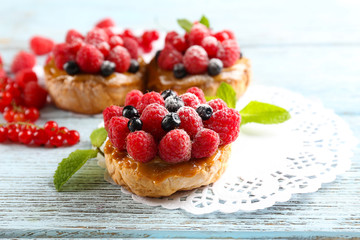 Sweet cakes with berries on table close-up
