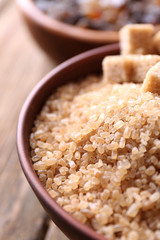Brown sugar cubes, reed and crystal sugar in bowls