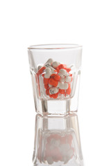Medicine in glass on white background