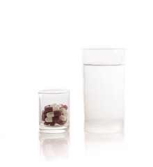 Medicine in glass and water ready to drug on white background