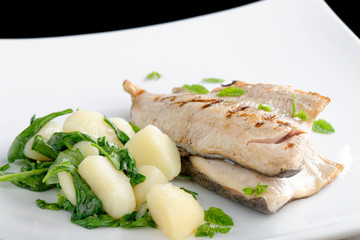 Grilled white fish fillets with potato and spinach