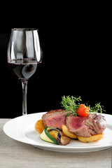 A dinner setting: Juicy grilled bbq steaks with fresh herbs