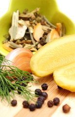 Halves of pickled cucumber and spices for pickling