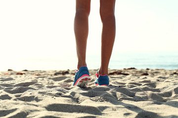 woman running on  the beach. closeup on shoe.