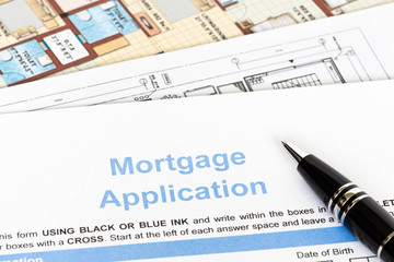 House mortgage application with pen and construction plan