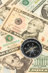 Compass on dollar banknote concept for financial direction