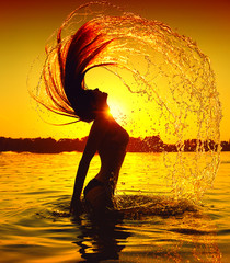 Beauty Model Girl Splashing Water with her Hair