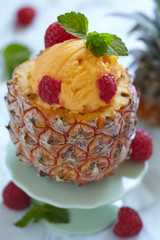 Fruit sorbet ice cream in small pineapple