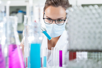 Woman analyzing liquid in test tube