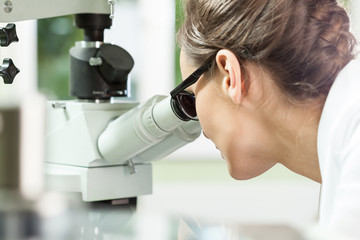 Woman working with microscope