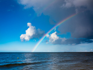 landscape view on sky with rainbow at sea.