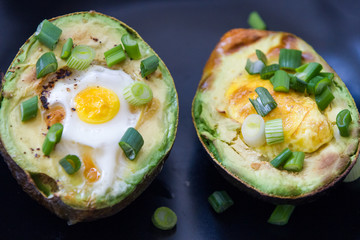 Eggs baked in avocado garnished with green onions