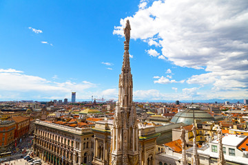 A statue of the Dome of Milan cathedral with the city view
