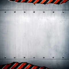 cracked metal plate with warning stripes