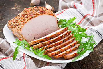 Baked pork decorated with arugula leaves