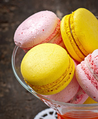 French colorful macarons on a wooden background