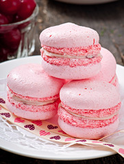 French colorful macarons on a wooden background