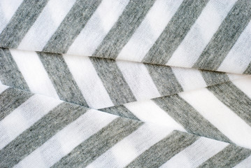 Folded gray and white striped cotton polyester texture.