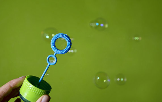 Bubble blower over green background