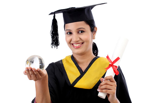 Young female graduated student holding a glass globe