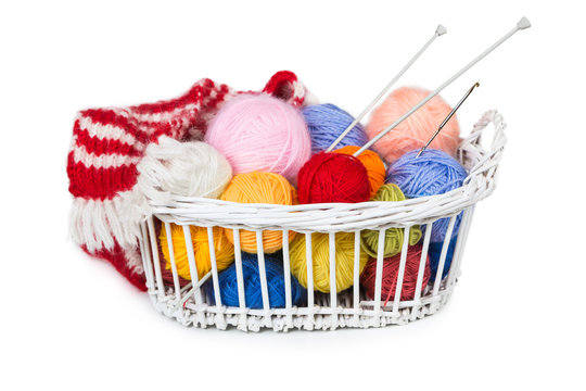 Wicker basket with colorful balls of yarn