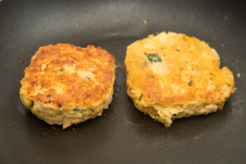Two Crab Cakes Frying
