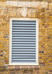 White Wood Shutters in Old Brick Wall