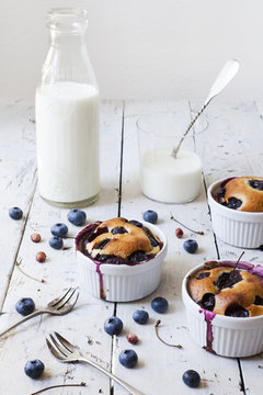 clafoutis with blueberries and cherries with milk bottle