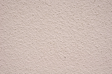 Light pink rough plaster on wall closeup
