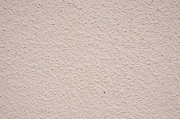 Light pink rough plaster on wall closeup