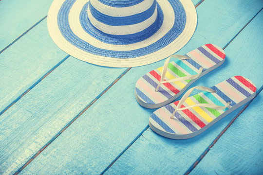 Beach Slippers And Hat On Blue Wood