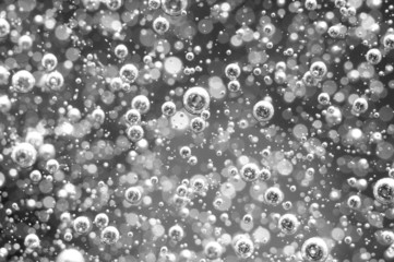 Air bubbles in a liquid. Abstract black-and-white background.