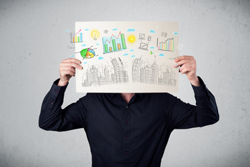Businessman holding a paper with charts and cityscape in front o