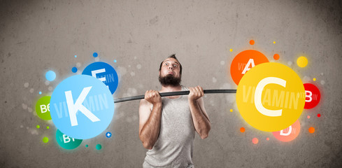 skinny guy lifting colorful vitamin weights